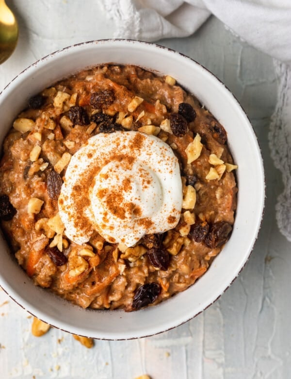 carrot cake oatmeal in a bowl topped with Greek yogurt and cinnamon