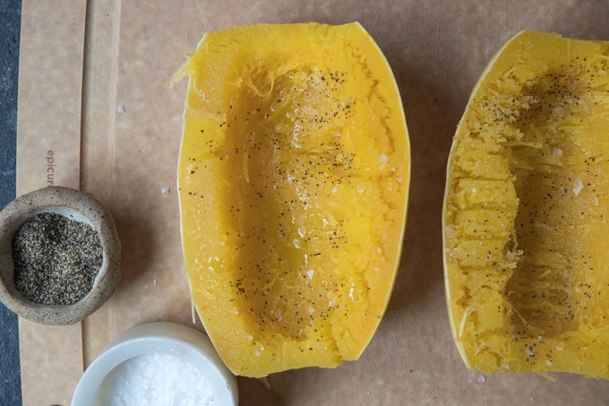 spaghetti squash cut in half, cooked and on a cutting board
