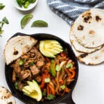 steak fajitas in a cast iron skillet