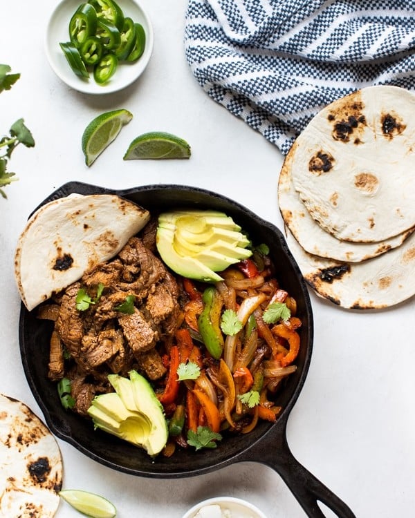 steak fajitas in a cast iron skillet