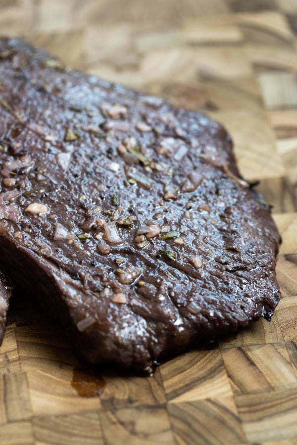 flank steak cooked on a cutting board
