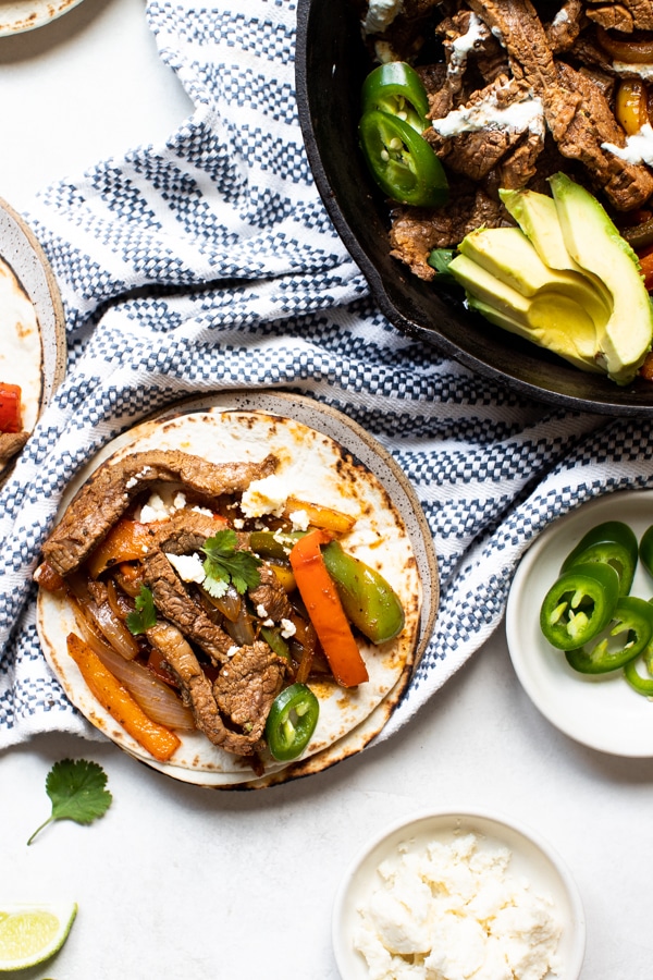 flank steak fajitas with a flour tortilla topped with cilantro