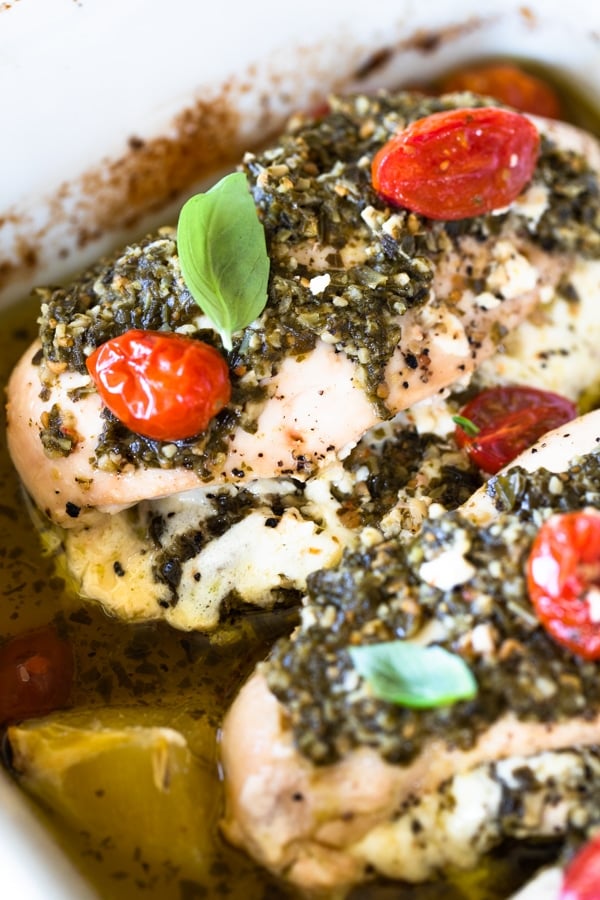 healthy pesto baked chicken in a baking pan