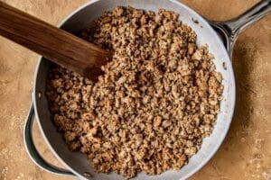 ground meat in a frying pan.