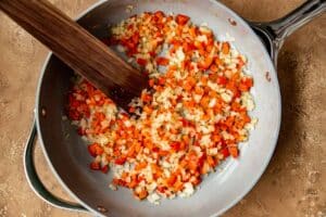 bell peppers and onions in a frying pan.