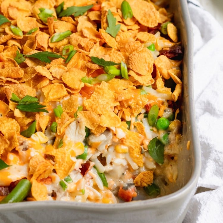 casserole in a casserole dish made with chicken and hash browns topped with cornflakes and fresh parsley