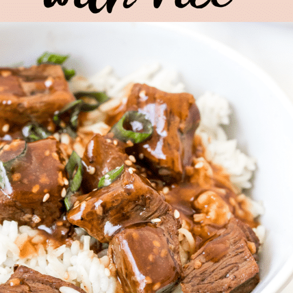 steak bites in a white bowl with white rice