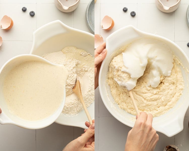 A side-by-side image showing the process of making pancake batter. On the left, a hand is pouring a bowl of mixed wet ingredients into a bowl containing dry ingredients, with a wooden spoon resting in the flour mixture. On the right, a hand is gently folding whipped egg whites into the thick pancake batter using a wooden spatula. The background features a tiled surface with scattered blueberries and broken eggshells.