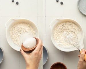 Two images showing the process of preparing the dry ingredients. On the left, a hand is pouring granulated sugar into a white mixing bowl filled with flour. On the right, a whisk is stirring the combined dry ingredients.