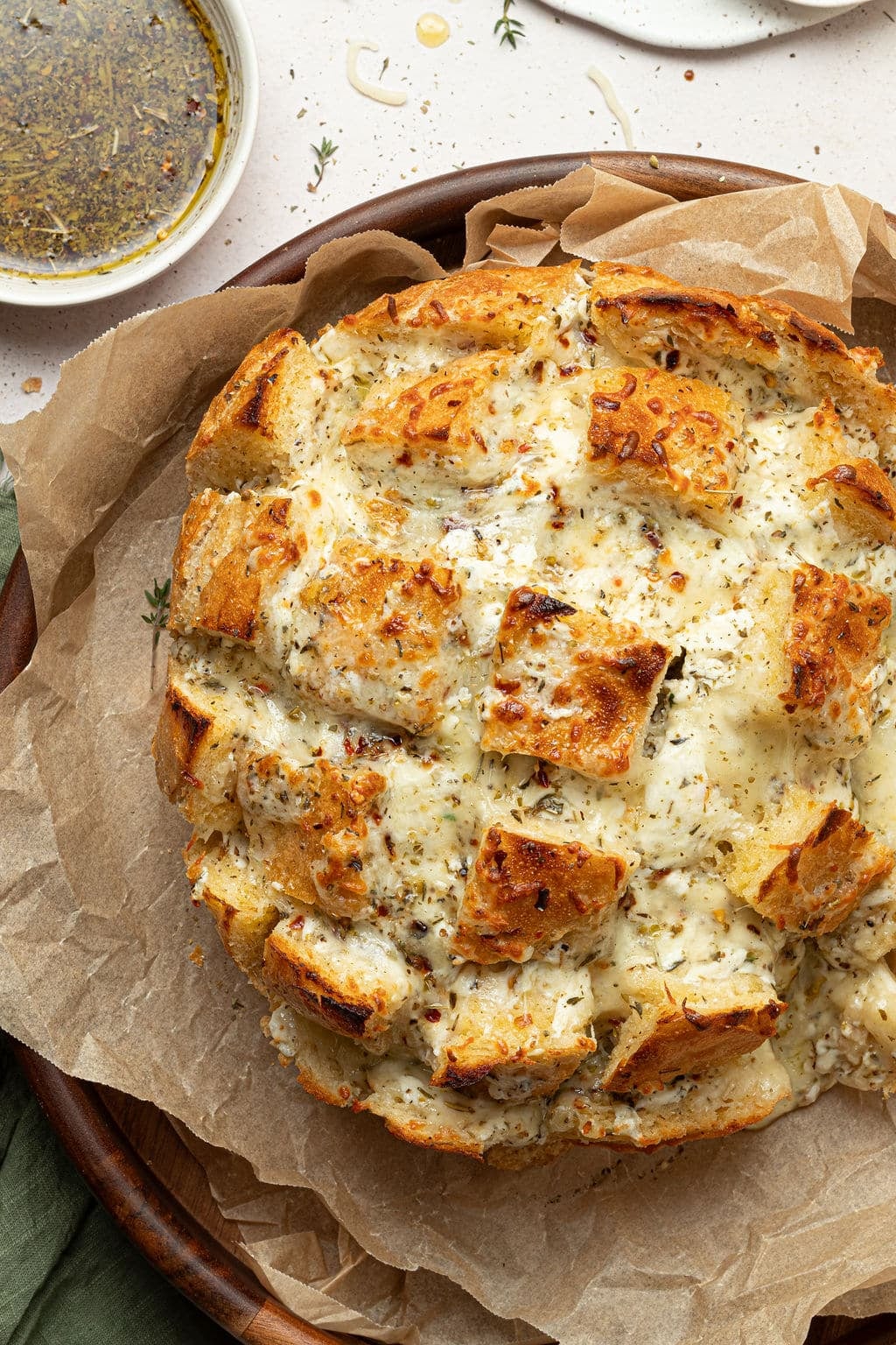 cheesy pull apart bread on serving dip with dipping oil