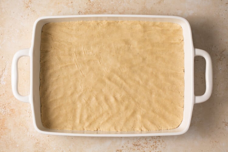 apple pie bars batter in a baking dish