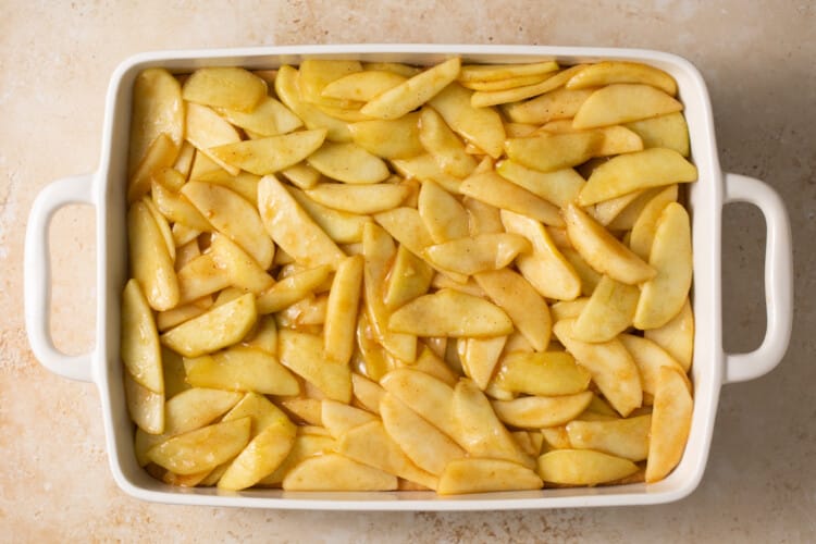 baking dish with apple pie bars sliced apple layer
