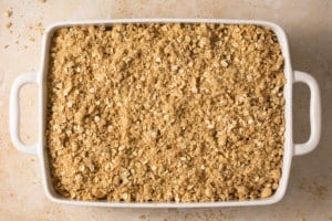 baking dish with apple pie bars topping layer