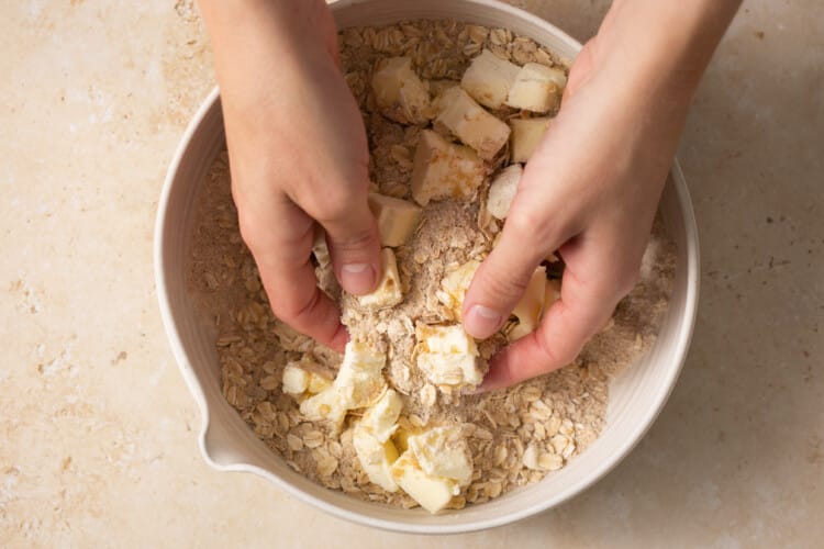 hands mixing dry ingredients
