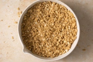 oat layer of apple pie bars in a circle dish