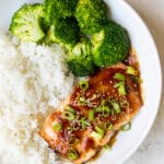 teriyaki glazed salmon in a white bowl with rice and broccoli