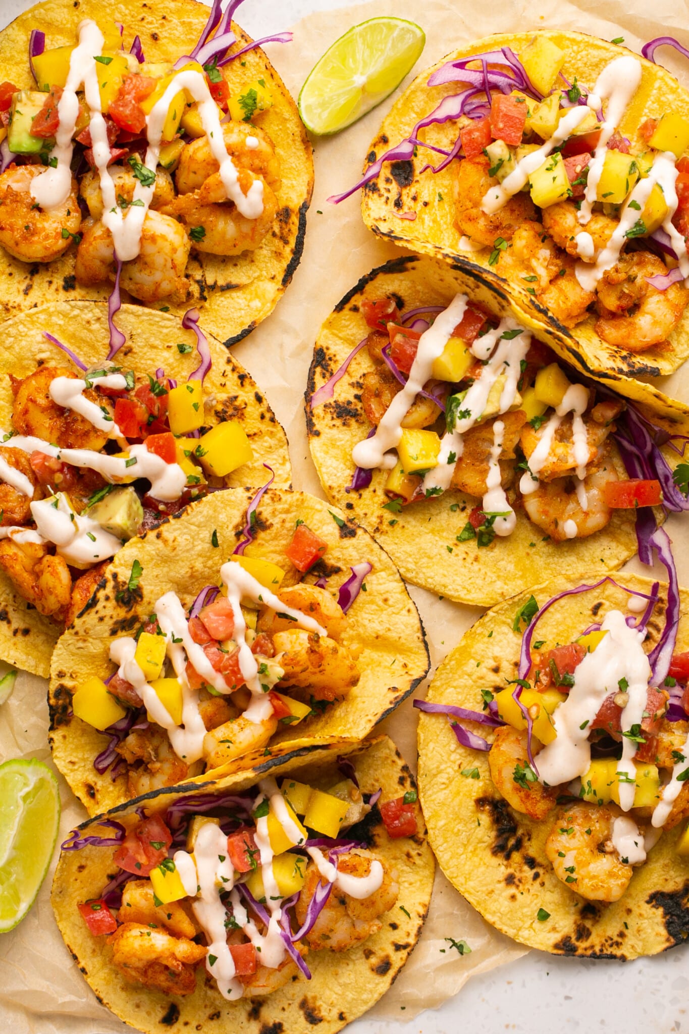 tacos with shrimp and taco sauce on top. 