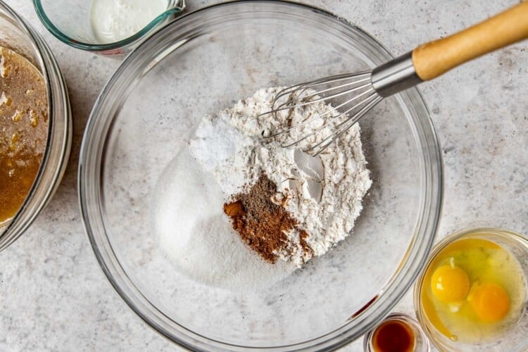 flour and spices in a large glass bowl with a whisk.