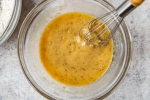 wet ingredients for banana bread in a large glass bowl.