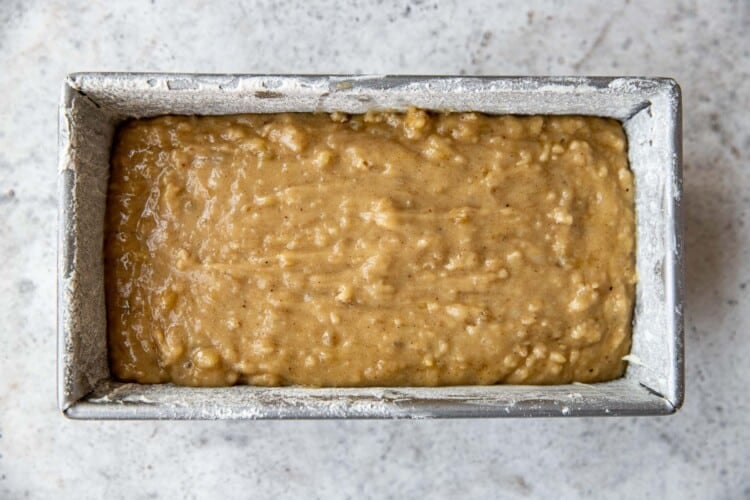 banana bread batter poured into a loaf pan.