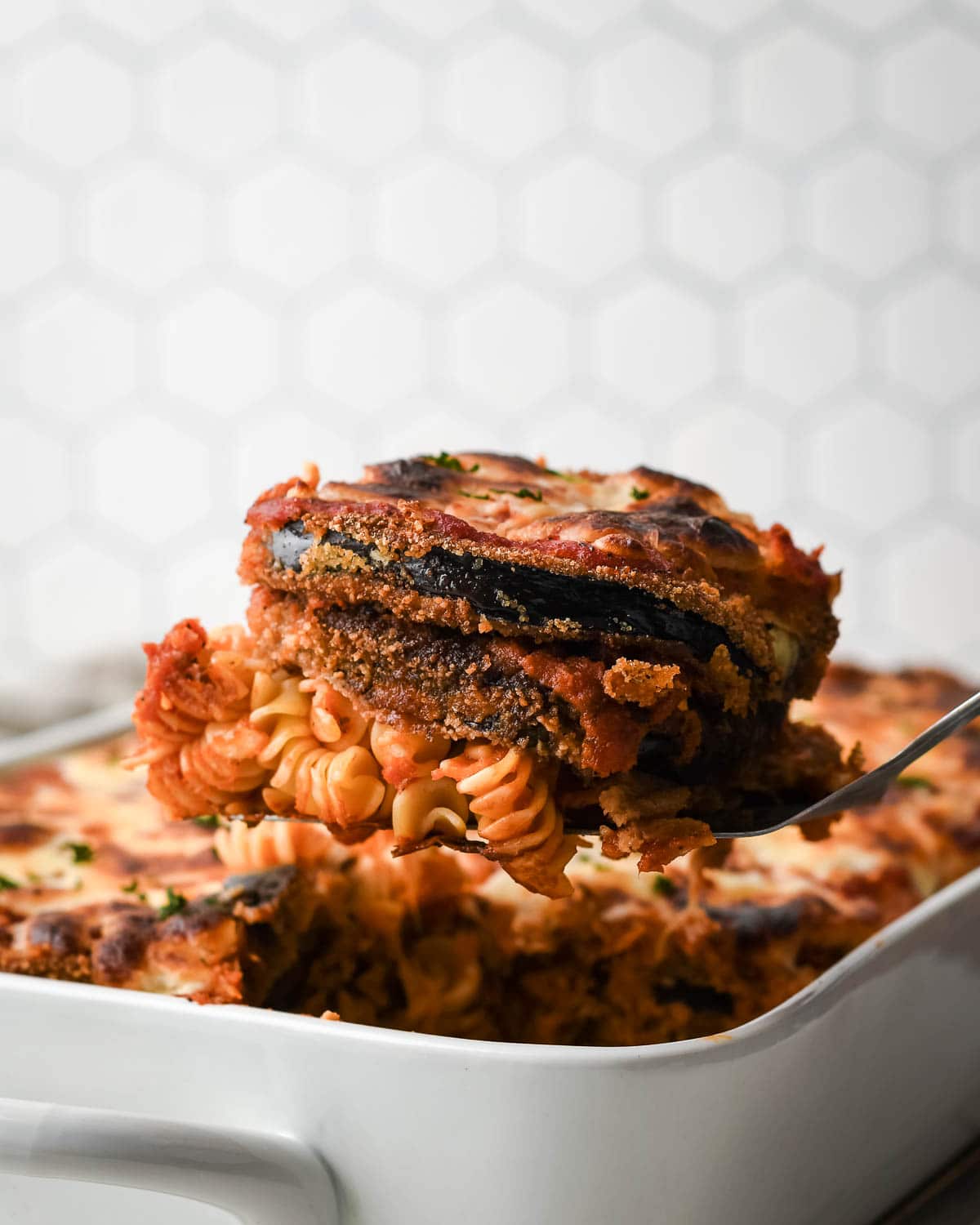 a serving of eggplant parmesan with pasta