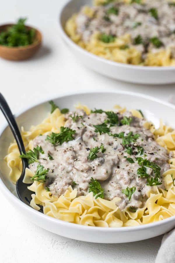 Ground Turkey Stroganoff in a white bowl garnished with parsley