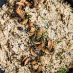 risotto topped with mushrooms in a pan