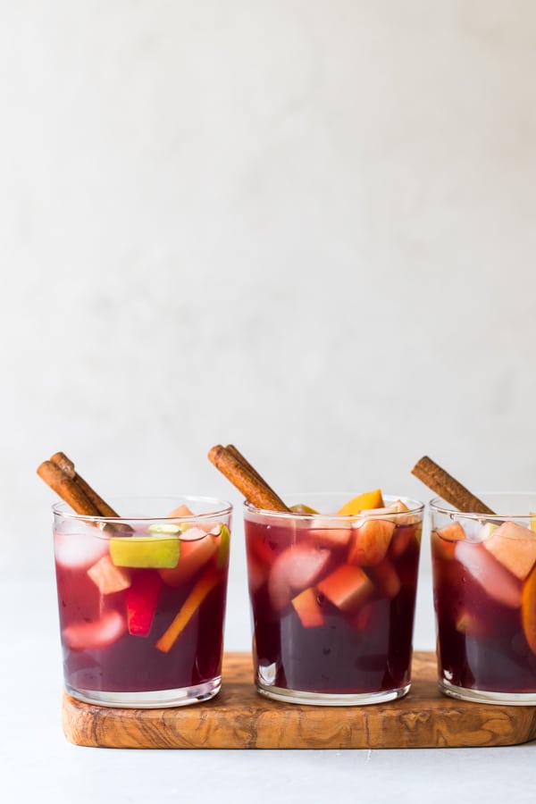 Fall sangria in glasses with a cinnamon stick