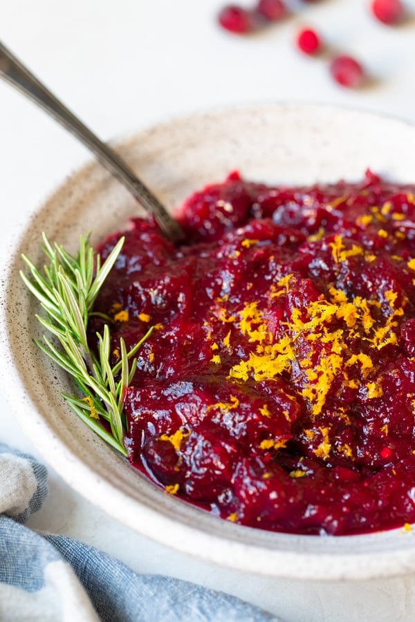 cranberry sauce in a bowl topped with orange zest