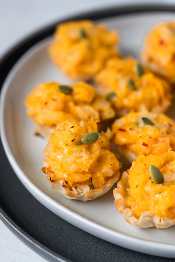 phyllo cups filled with butternut squash on a white plate