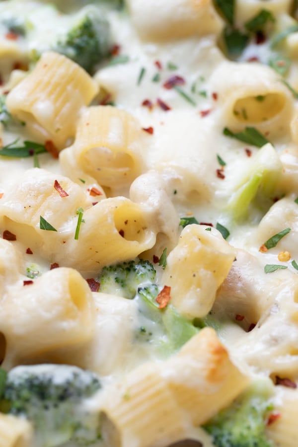 an up close photo of pasta covered in cheese and broccoli