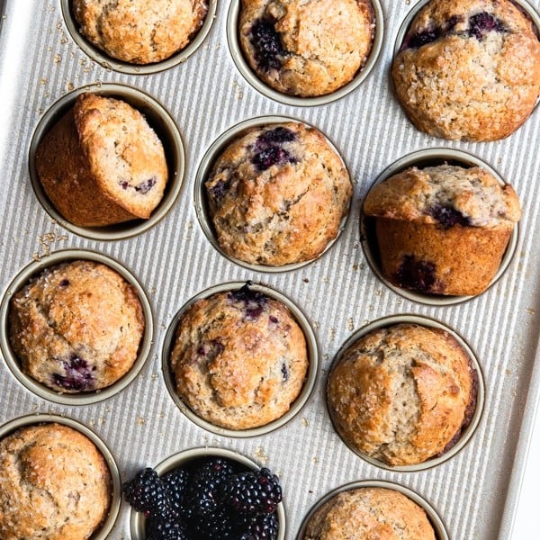 freshly baked blackberry muffins in a muffin tin