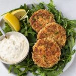 crab cakes on a bed of arugula