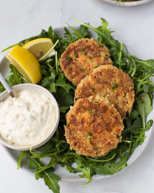 crab cakes on a bed of arugula
