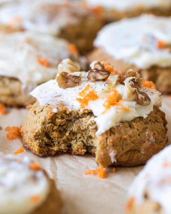 a bite taken out of a cookie with cream cheese frosting on top