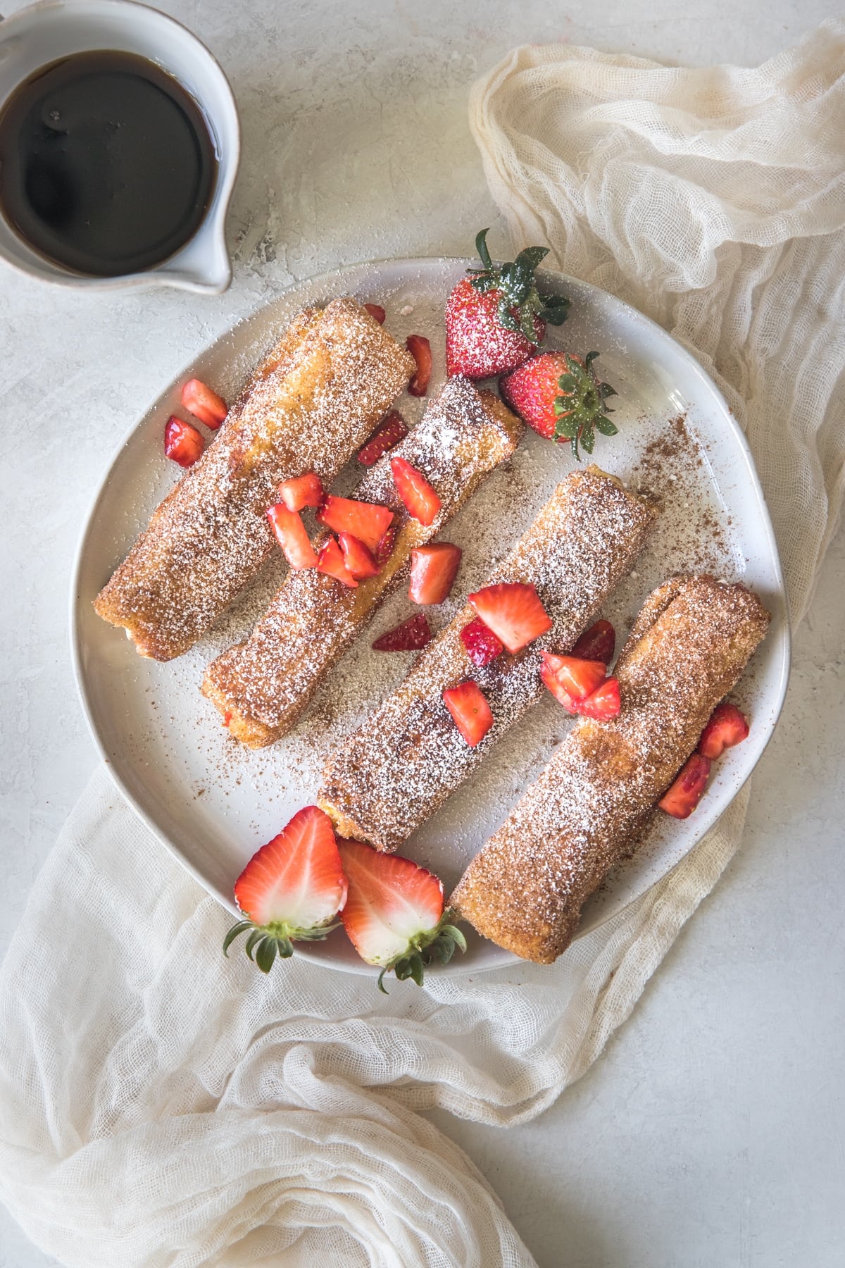 french toast on a white plate with strawberries