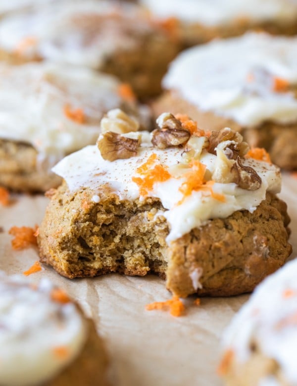 a bite taken out of a cookie with cream cheese frosting on top