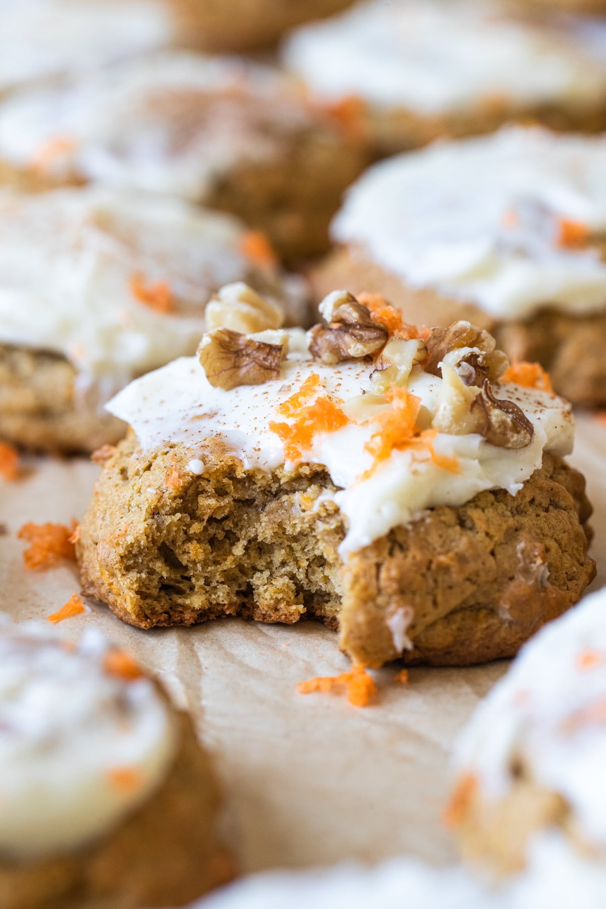 a bite taken out of a cookie with cream cheese frosting on top
