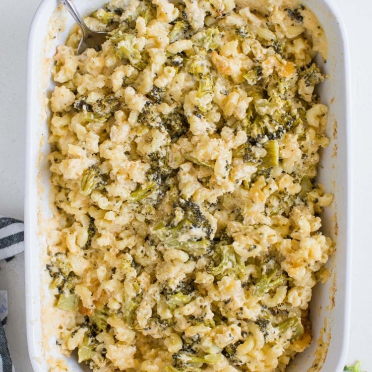 macaroni and cheese with broccoli in a white casserole dish