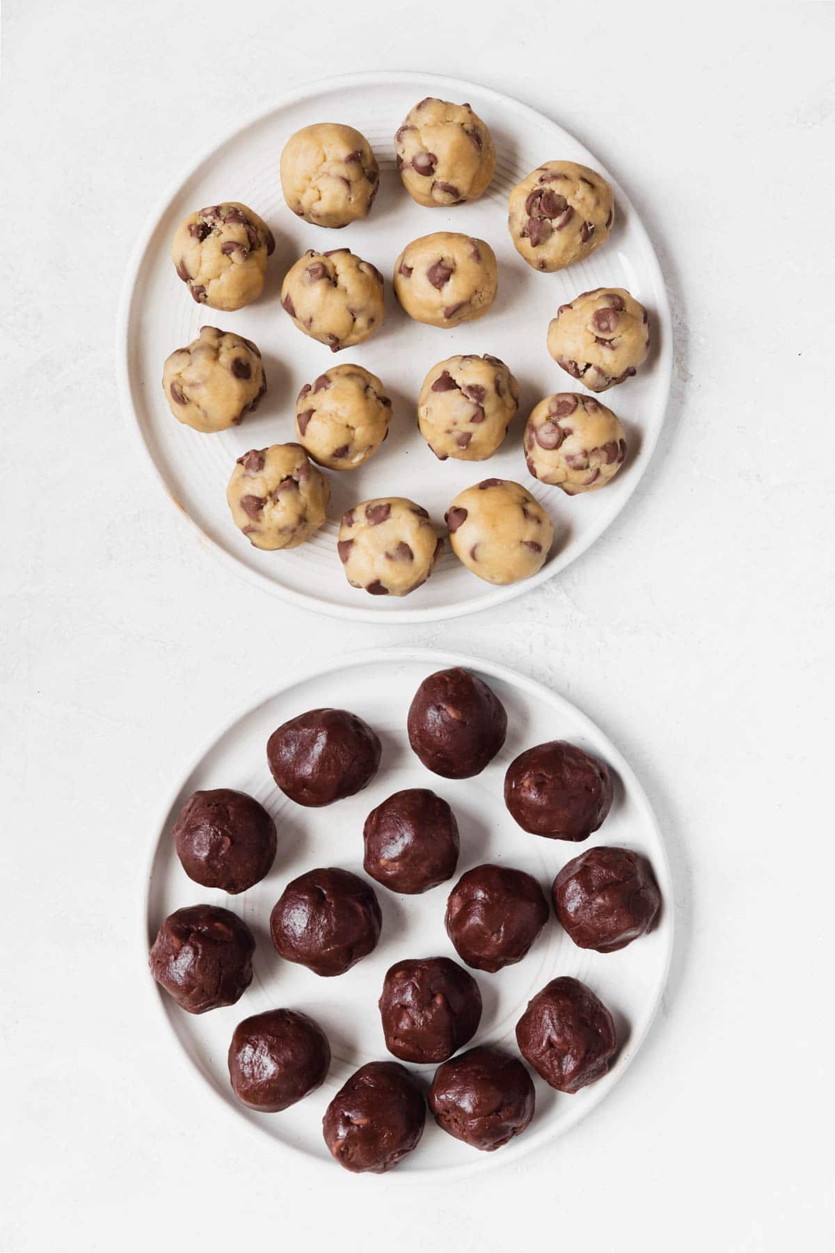 brownie batter cookie dough on a white plate and chocolate chip cookie dough on a white plate