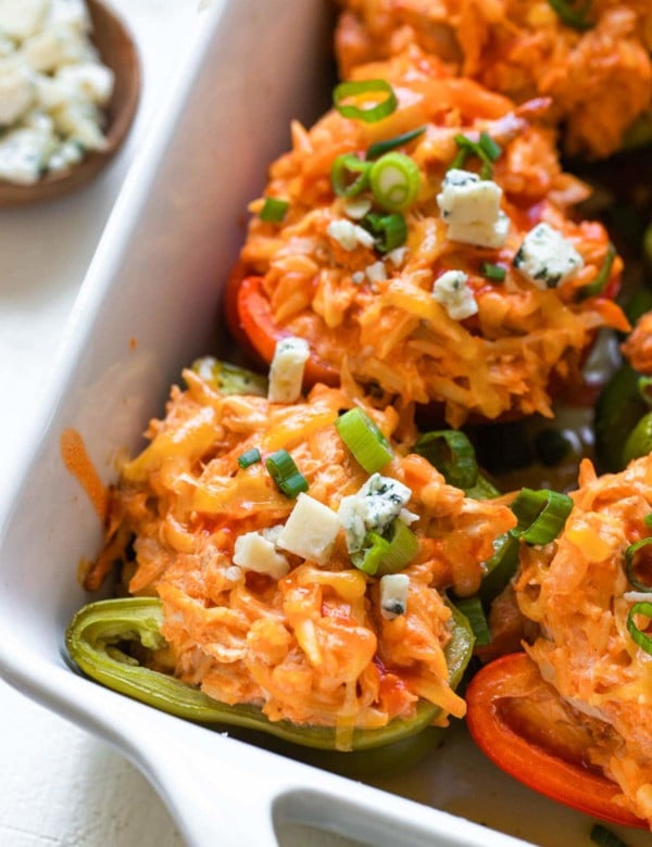 stuffed peppers in a white casserole dish