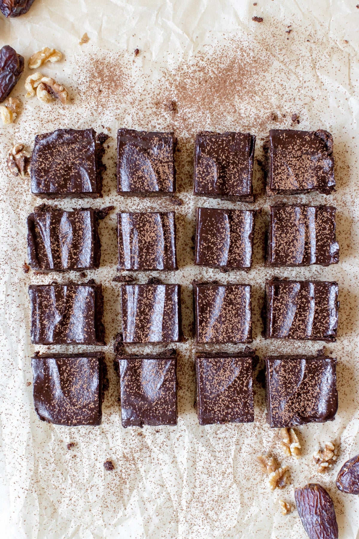 brownies on parchment paper dusted with cocoa powder