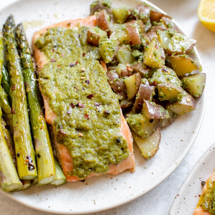 salmon with potatoes and asparagus on a white plate
