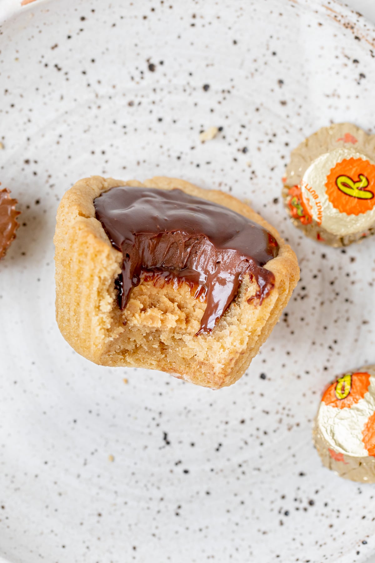 a bite taken out of a peanut butter cup cookie