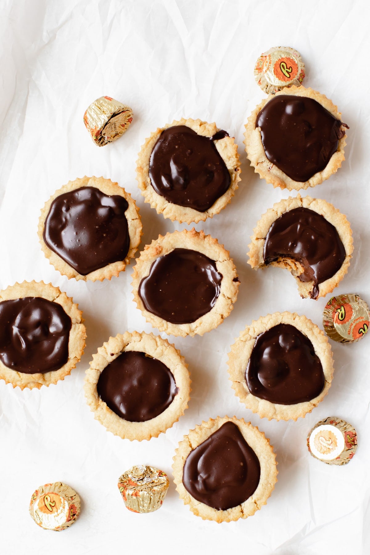 cookies on parchment paper with peanut butter cup candies