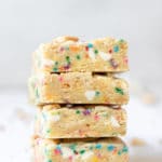a close up photo of funfetti cookie bars stacked on top of each other