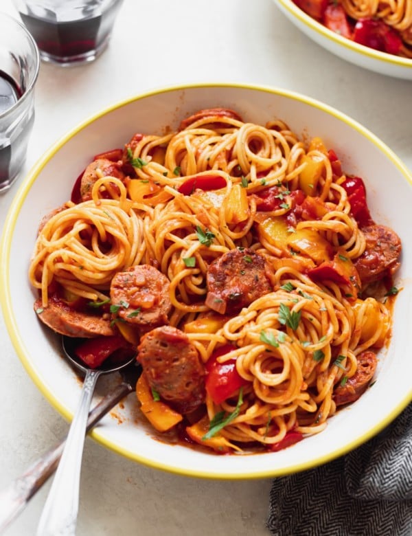 sausage and spaghetti in a white bowl