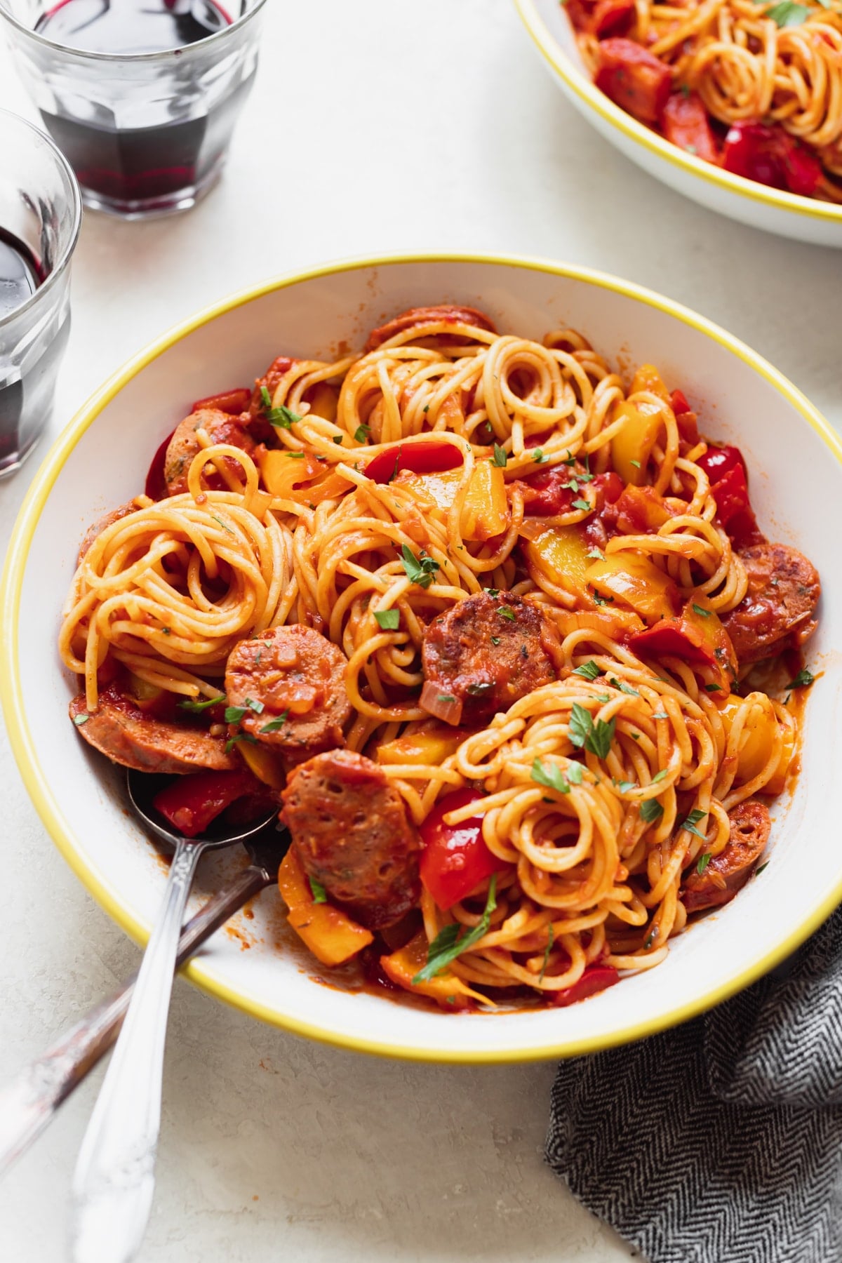 sausage and spaghetti in a white bowl