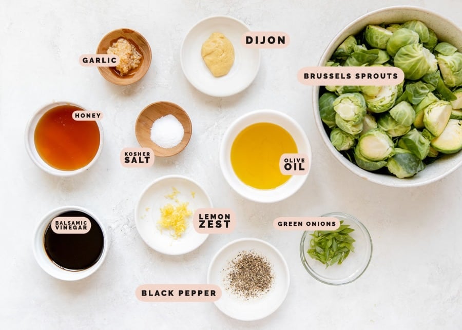 ingredients needed to make roasted brussels in small white bowls