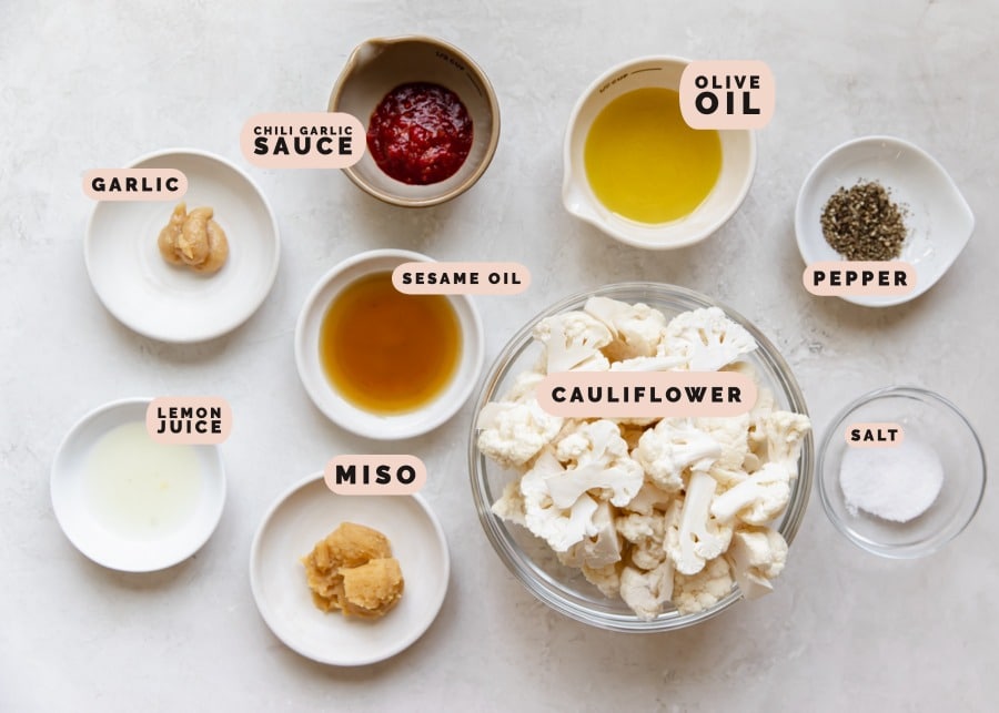 ingredients to make roasted cauliflower in small glass bowls